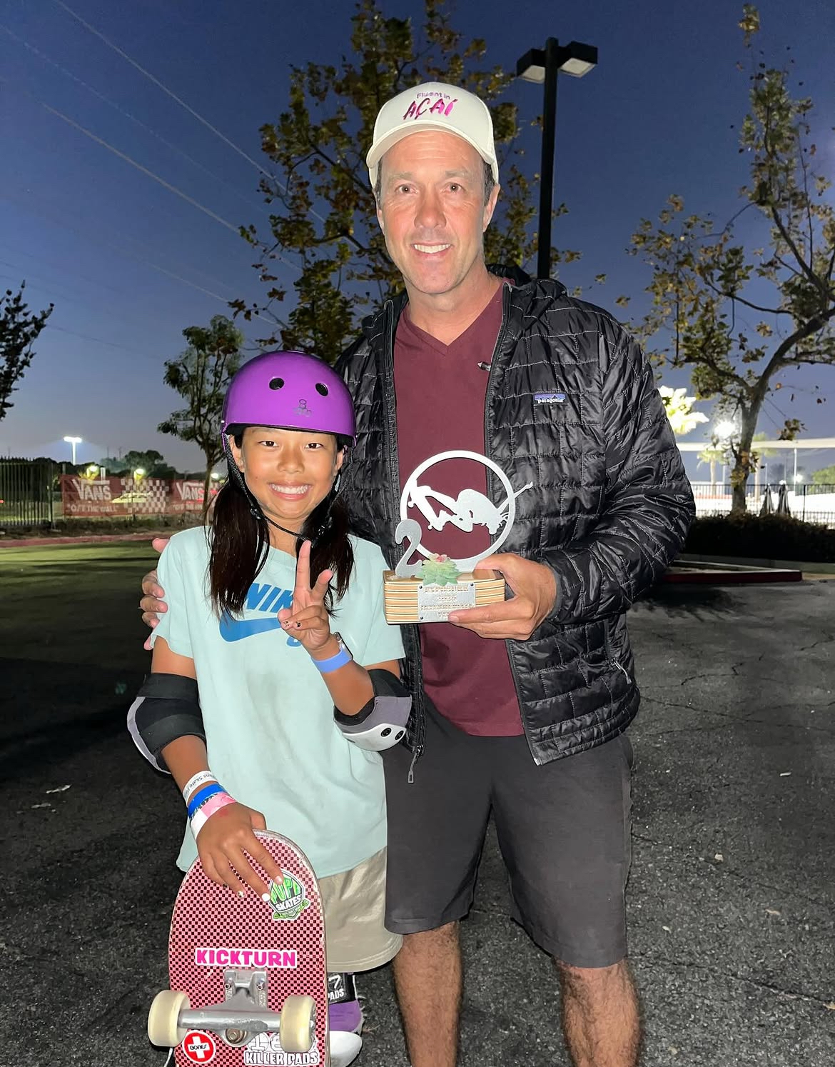Bruno Passos with a young skater holding a trophy at the skatepark