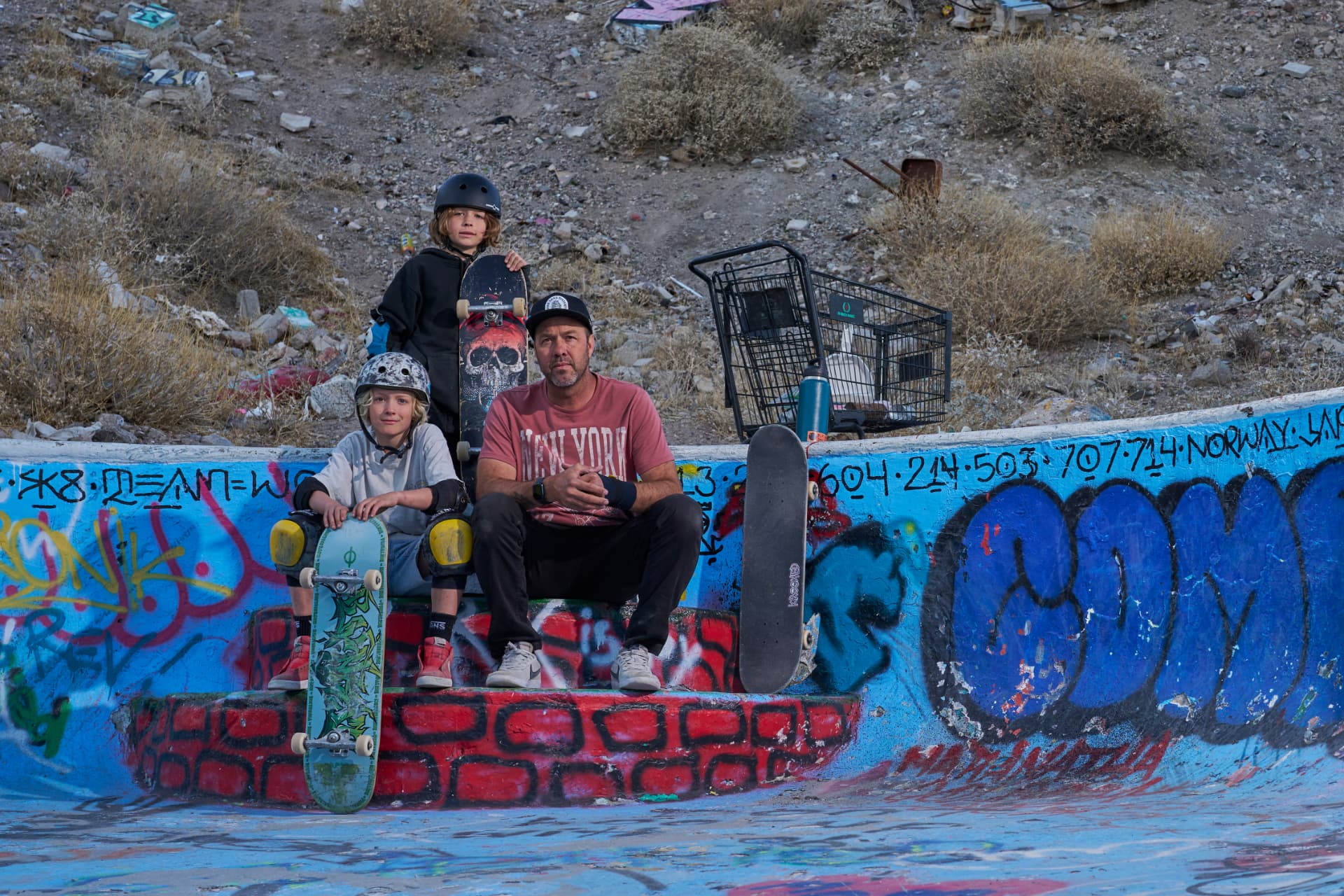 Bruno Passos sitting with young skaters at a graffiti bowl